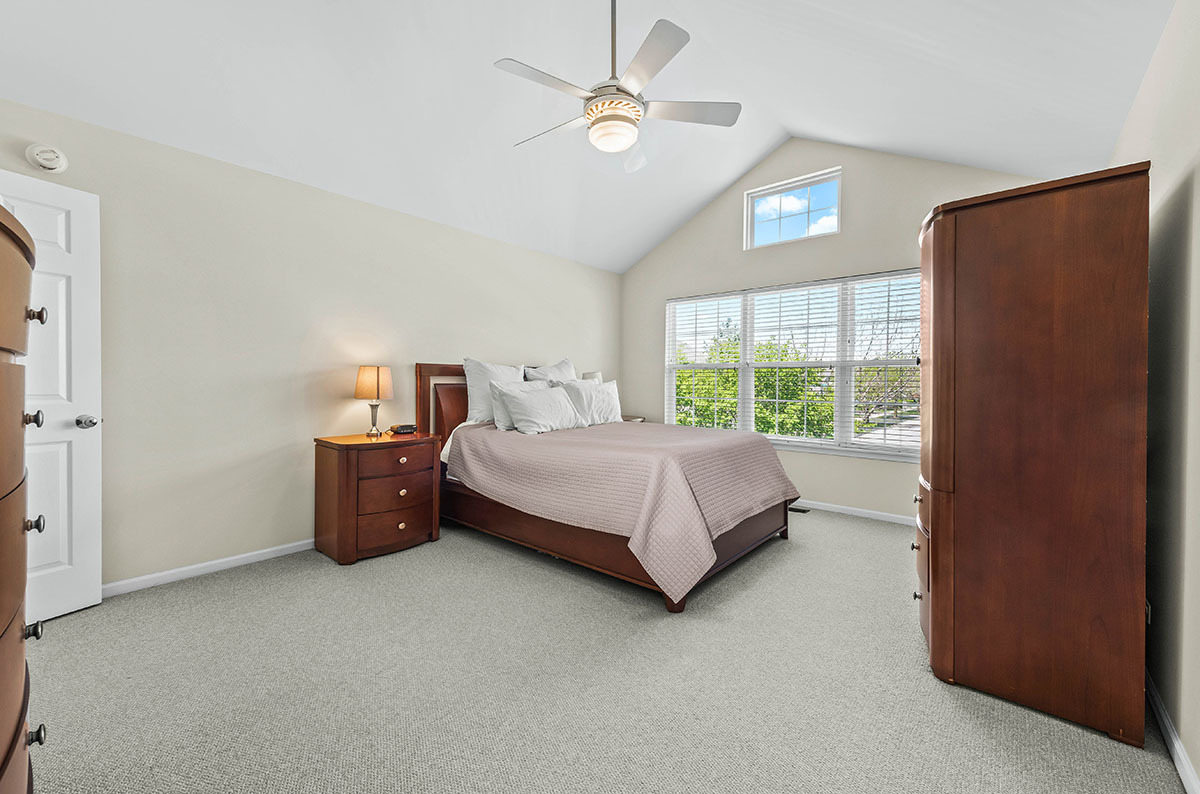 3058 Crystal Rock Road, Unit 3058 Naperville, IL 60564 - Photo 11 of 21 a bedroom with a bed dresser and a window