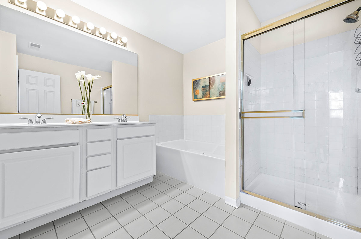 3058 Crystal Rock Road, Unit 3058 Naperville, IL 60564 - Photo 12 of 21 a bathroom with a double vanity sink mirror and shower