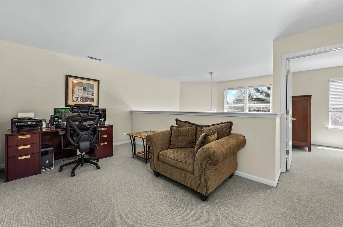 3058 Crystal Rock Road, Unit 3058 Naperville, IL 60564 - Photo 15 of 21 a living room with furniture and a flat screen tv