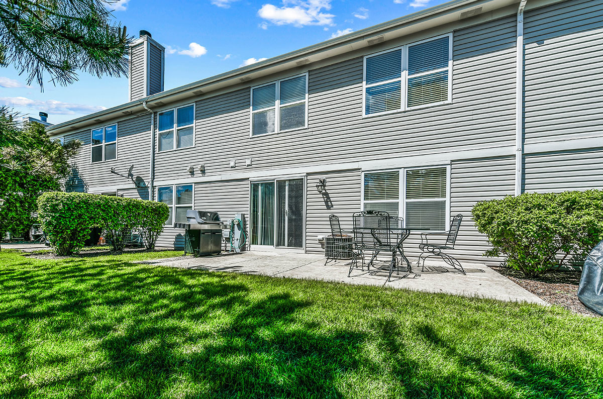 3058 Crystal Rock Road, Unit 3058 Naperville, IL 60564 - Photo 19 of 21 a front view of house with a garden and patio