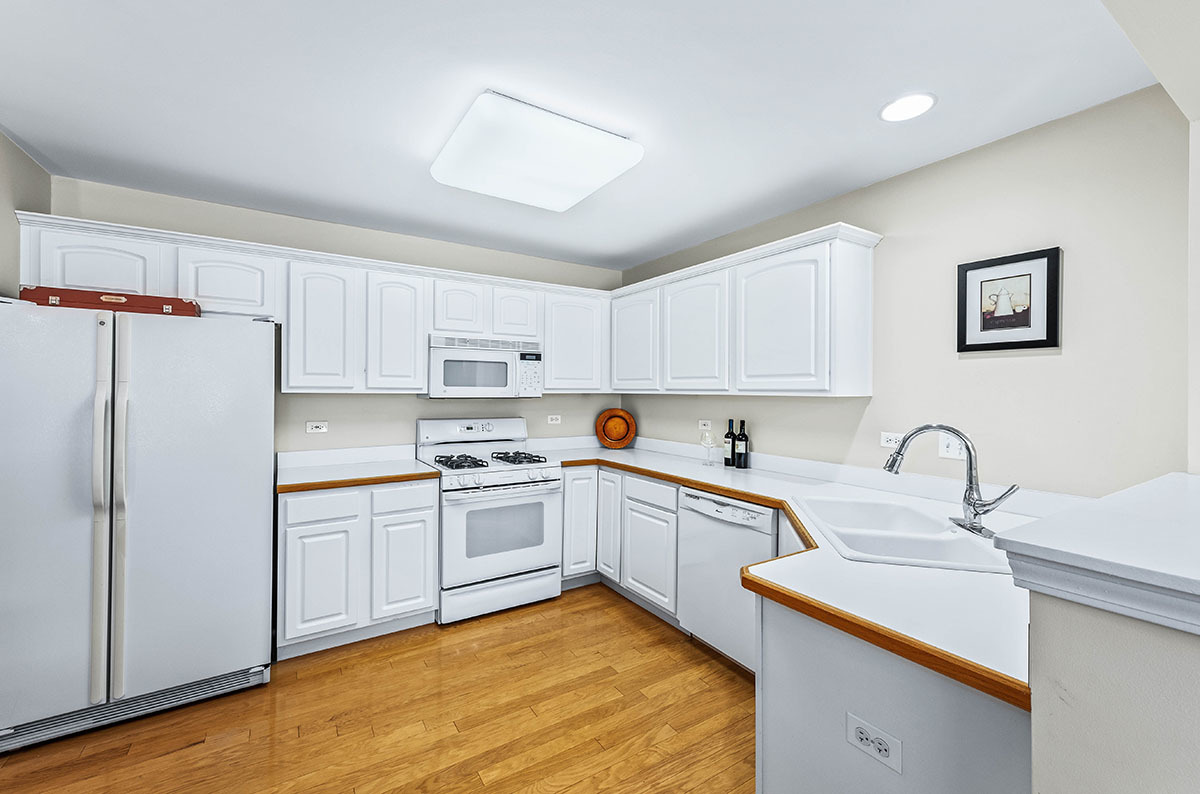 3058 Crystal Rock Road, Unit 3058 Naperville, IL 60564 - Photo 3 of 21 a kitchen with white cabinets sink and refrigerator