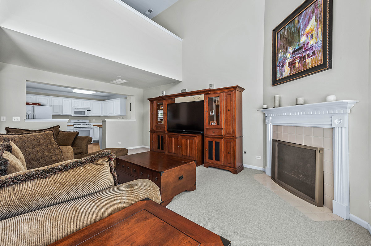3058 Crystal Rock Road, Unit 3058 Naperville, IL 60564 - Photo 5 of 21 a living room with furniture and a flat screen tv