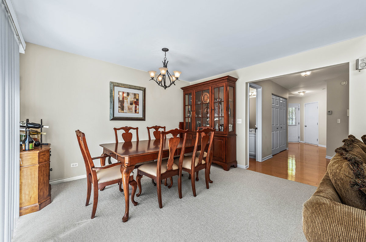 3058 Crystal Rock Road, Unit 3058 Naperville, IL 60564 - Photo 7 of 21 a view of a dining room with furniture and chandelier