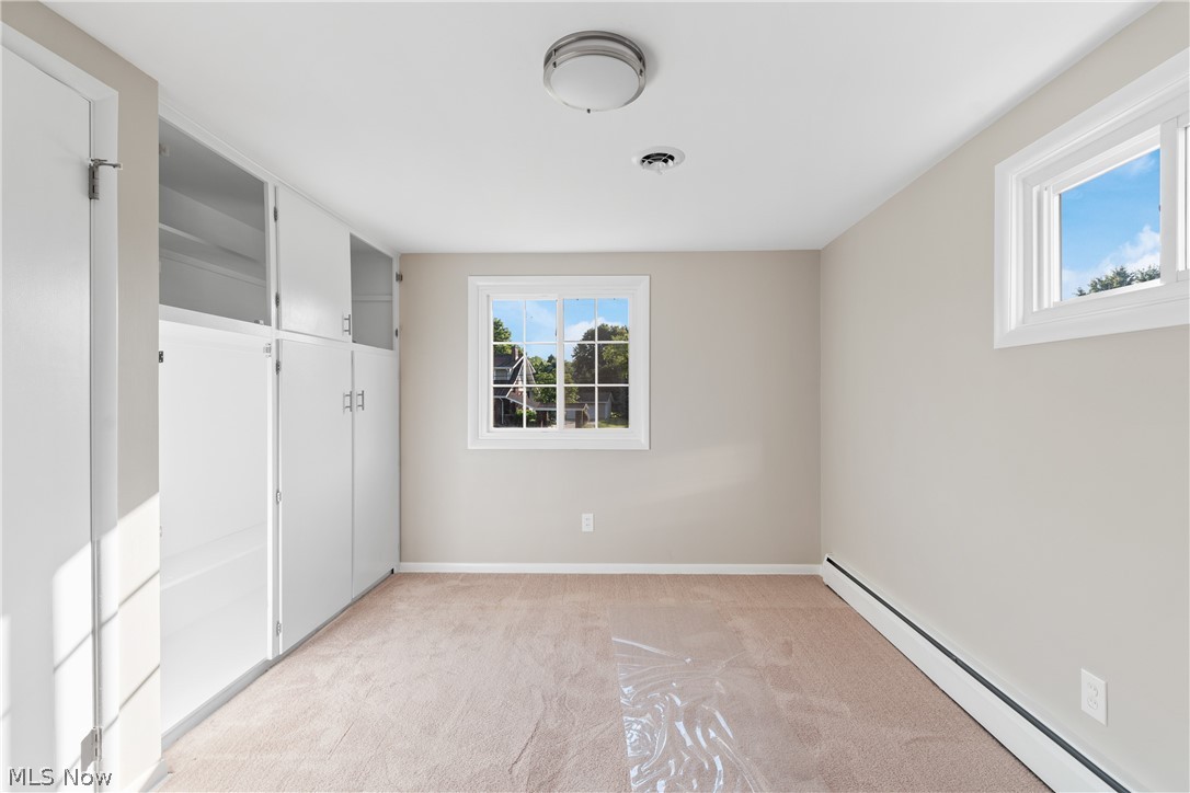 1332 Perry Drive Northwest Canton, OH 44708 - Photo 20 of 32 Spare room with light carpet and baseboard heating