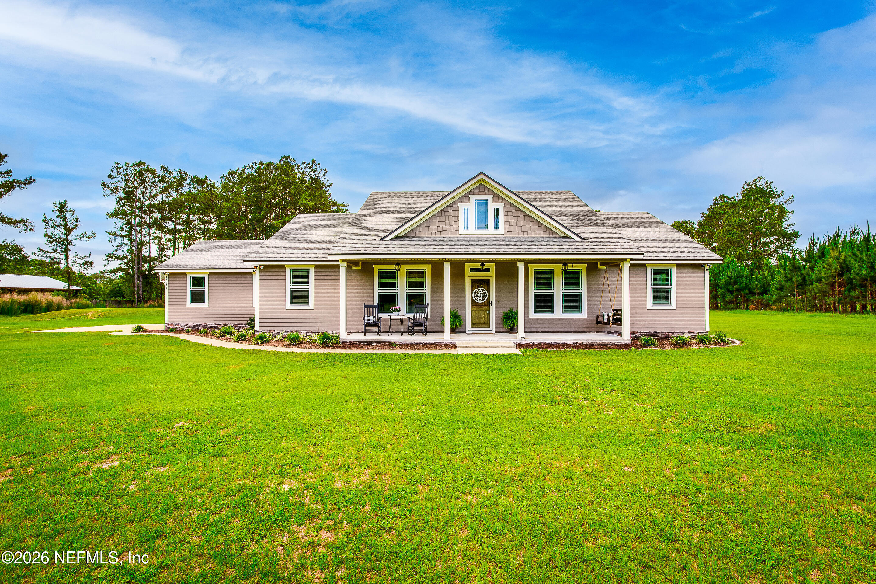26575 Sheared Stokes Road Hilliard, FL 32046 - Photo 1 of 39 a front view of a house with a garden