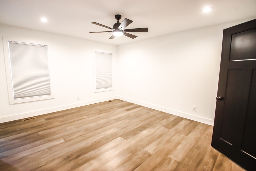 191 Rustling Oaks Drive Sparta, TN 38583 - Photo 13 of 20 a view of empty room with wooden floor and fan