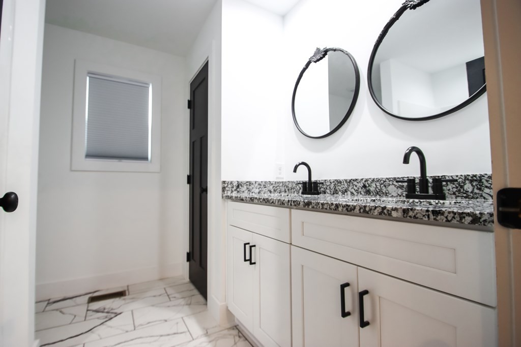 191 Rustling Oaks Drive Sparta, TN 38583 - Photo 14 of 20 a bathroom with a granite countertop toilet sink and mirror
