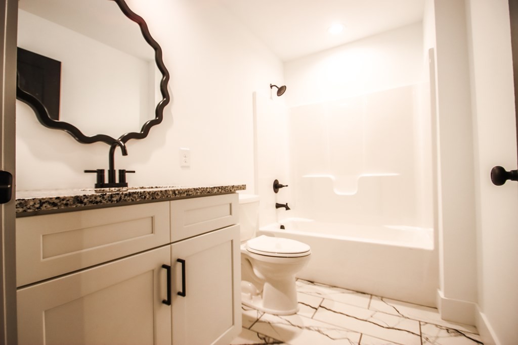 191 Rustling Oaks Drive Sparta, TN 38583 - Photo 17 of 20 a bathroom with a toilet a sink and a mirror