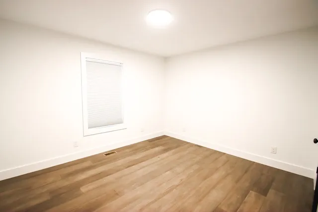 a view of a white house with a yard and table and chairs