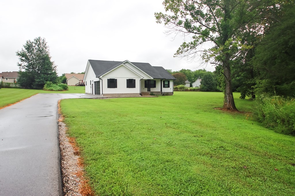 191 Rustling Oaks Drive Sparta, TN 38583 - Photo 2 of 20 a front view of a house with yard and green space