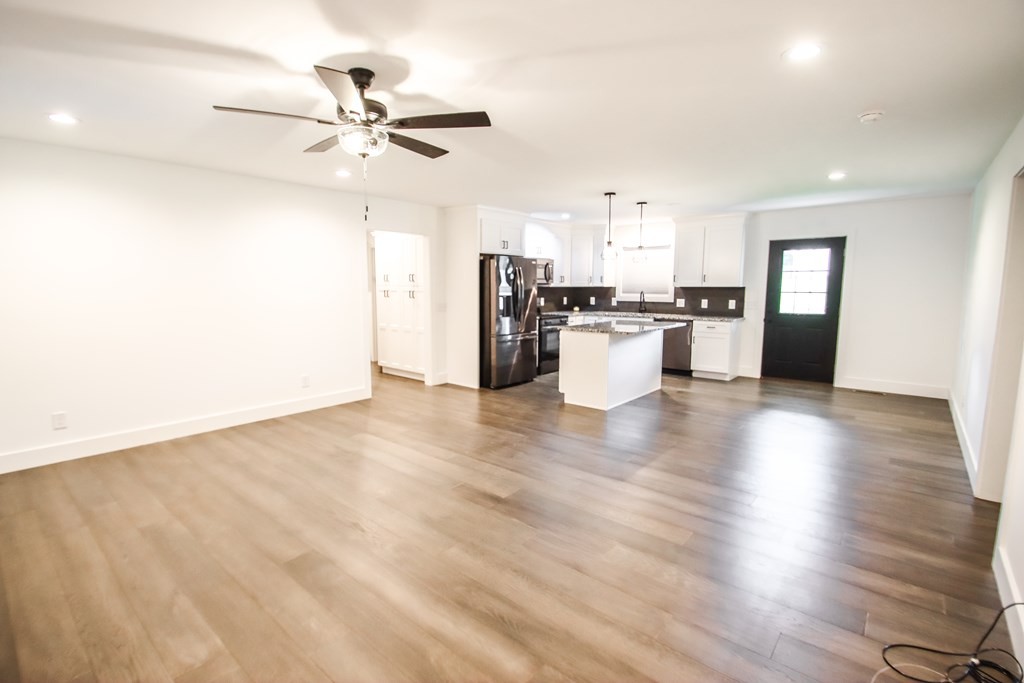 191 Rustling Oaks Drive Sparta, TN 38583 - Photo 8 of 20 a view of a kitchen with refrigerator stove and wooden floor