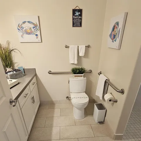 a bedroom with a bed and a flat tv screen on dresser