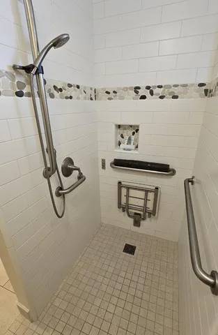 a bedroom with a bed a flat screen tv and dresser