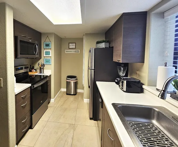 a kitchen with a sink stove and refrigerator