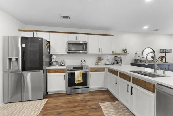 a kitchen with a sink cabinets and stainless steel appliances