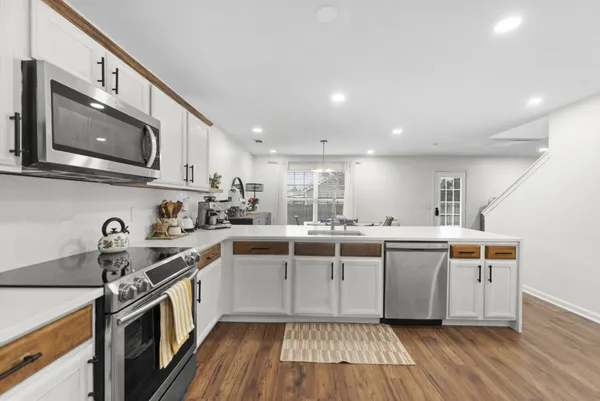 a kitchen with stainless steel appliances granite countertop a sink and stove top oven