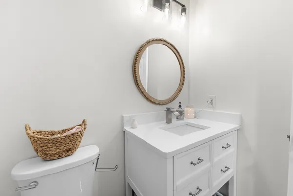 a bathroom with a toilet a sink and a mirror