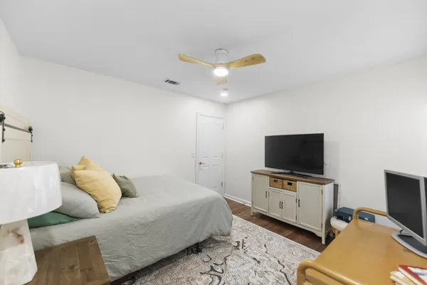 a bedroom with a bed and a flat screen tv