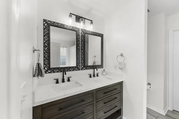 a bathroom with a double vanity sink mirror and