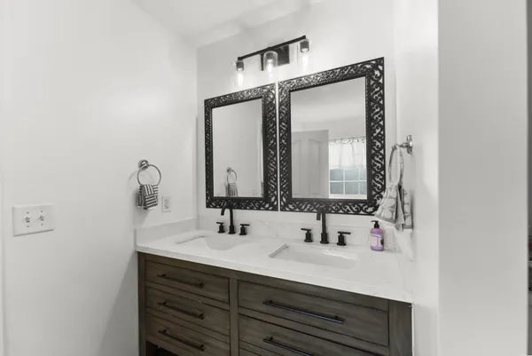 a bathroom with a sink vanity and a mirror