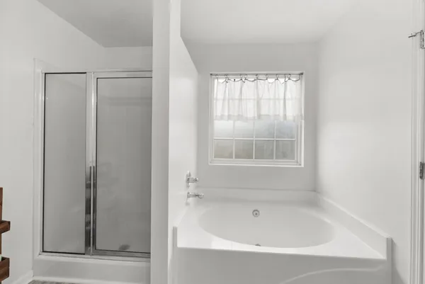 a white bath tub sitting next to a window