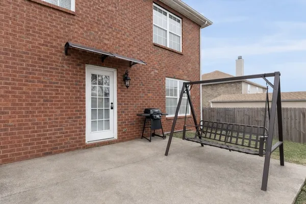 a view of backyard with wooden fence