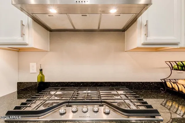 a stove top oven sitting inside of a kitchen