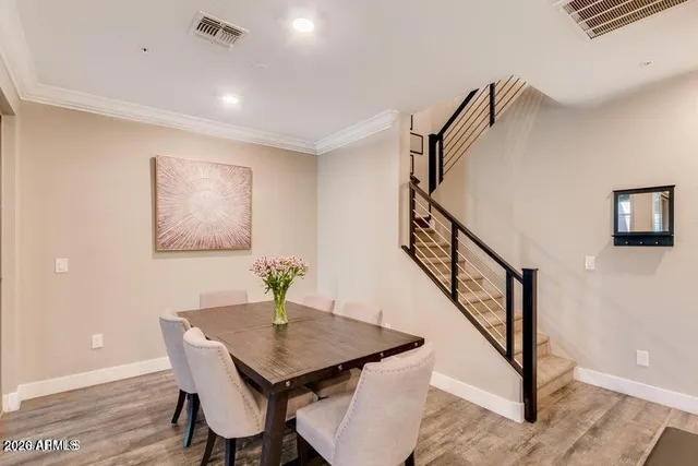 a view of a dining room with furniture and wooden floor
