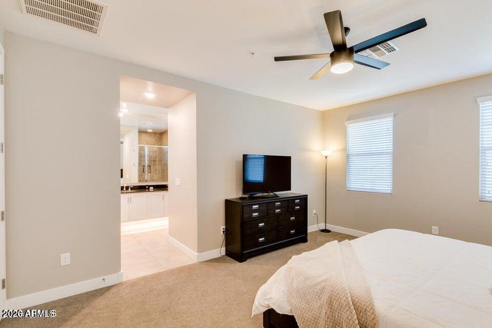 3855 South McQueen Road, Unit 14 Chandler, AZ 85286 - Photo 16 of 31 a bedroom with a bed and a flat tv screen on dresser