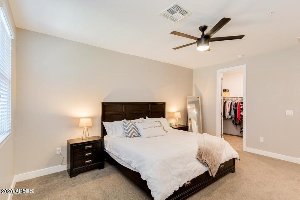 3855 South McQueen Road, Unit 14 Chandler, AZ 85286 - Photo 17 of 31 a bed room with a bed and a ceiling fan