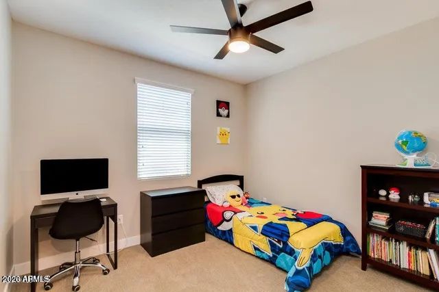 a bedroom with a bed and a bookshelf