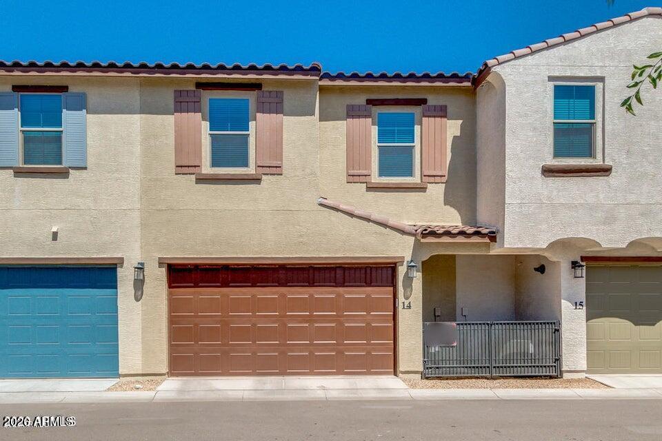 3855 South McQueen Road, Unit 14 Chandler, AZ 85286 - Photo 24 of 31 a front view of a house with a garden