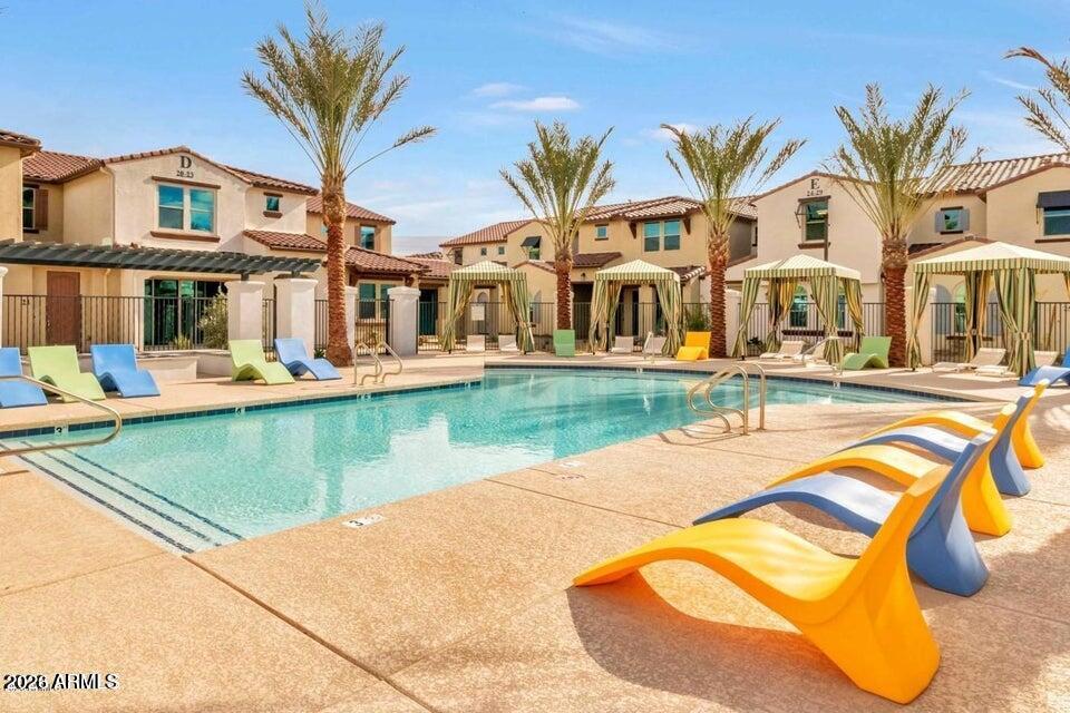 3855 South McQueen Road, Unit 14 Chandler, AZ 85286 - Photo 28 of 31 a view of a swimming pool with a lounge chairs