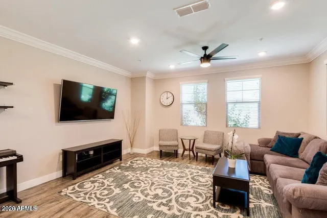a living room with furniture a flat screen tv and a fireplace