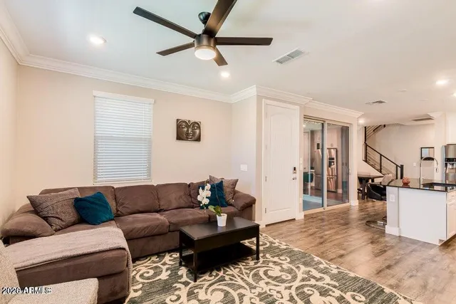 a living room with furniture and kitchen view