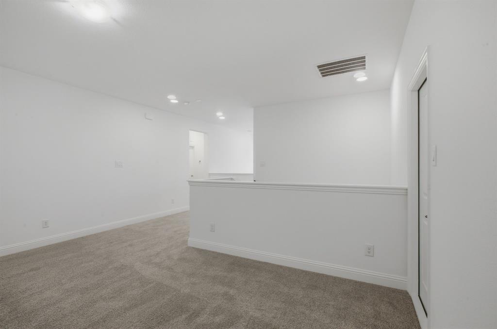 2911 Hanscom Street Forney, TX 75126 - Photo 37 of 40 Spacious room featuring neutral carpet flooring, white walls, and recessed lighting