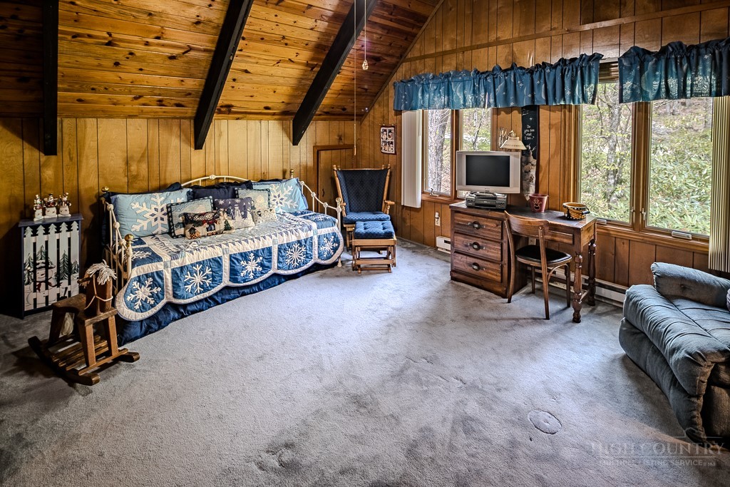107-109 Shagbark Road Beech Mountain, NC 28604 - Photo 42 of 45 a bedroom with furniture window and flat screen tv