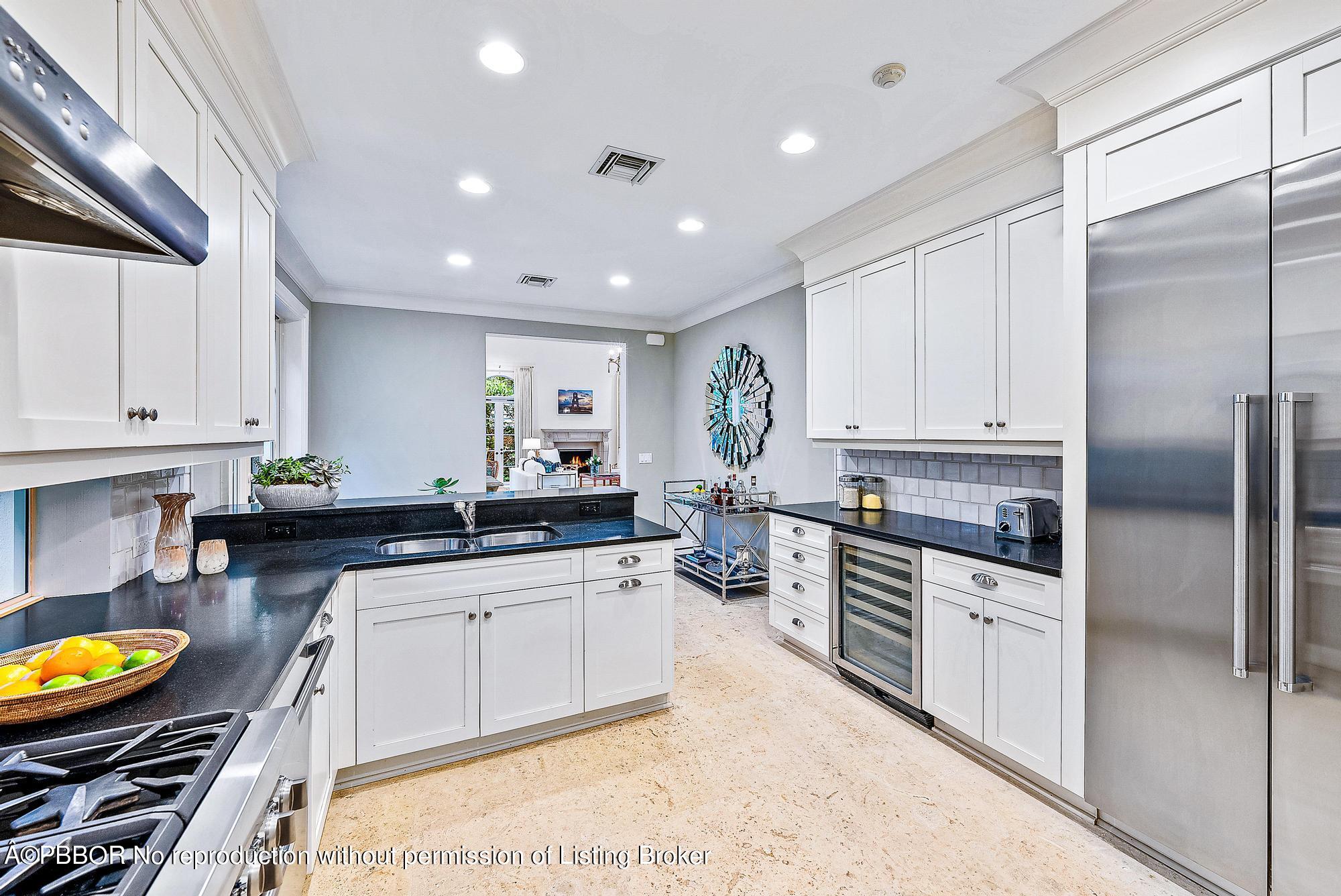 165 Root Trail Palm Beach, FL 33480 - Photo 12 of 26 a large kitchen with stainless steel appliances lots of counter space and a sink