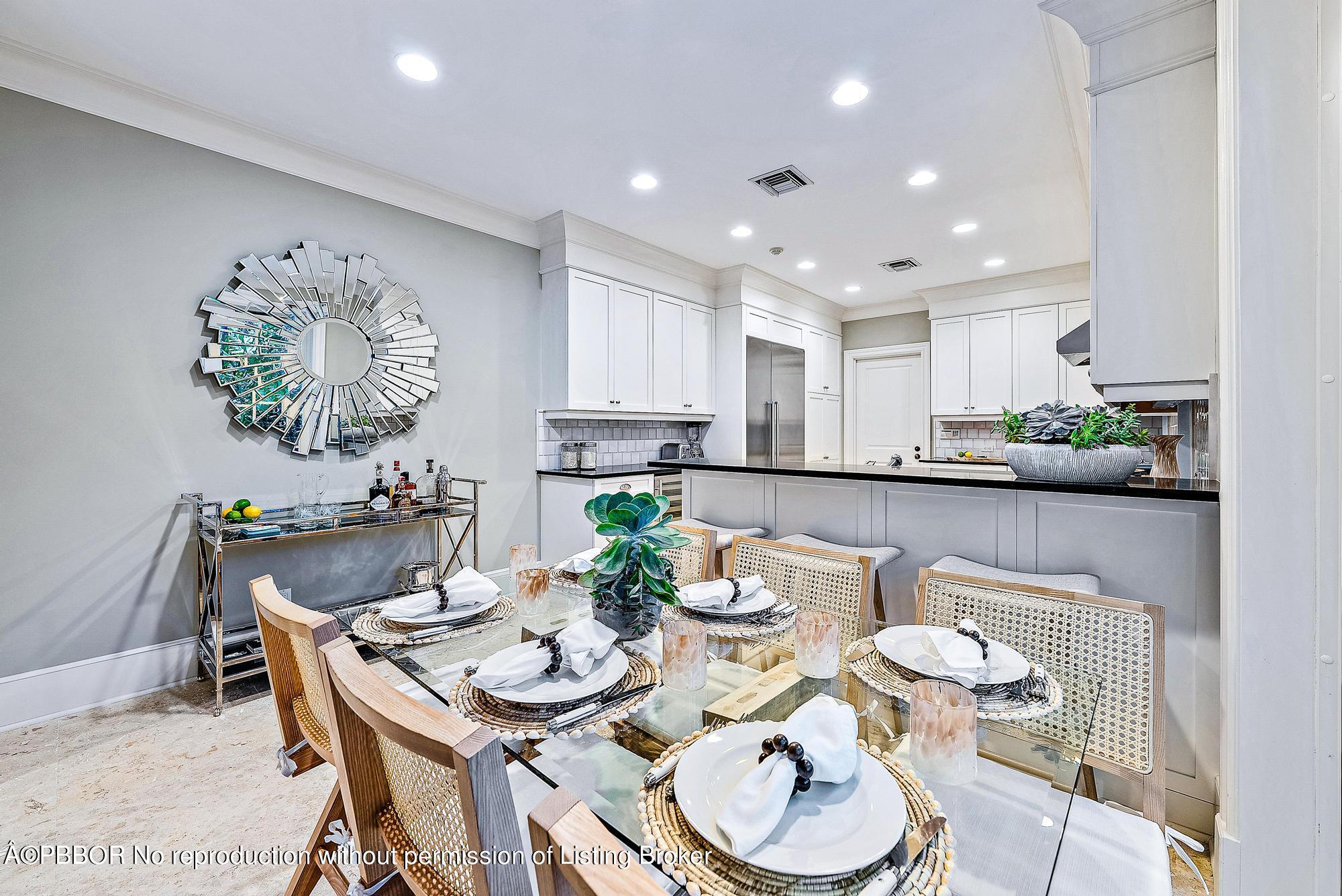 165 Root Trail Palm Beach, FL 33480 - Photo 13 of 26 a view of a dining room with furniture a rug and wooden floor