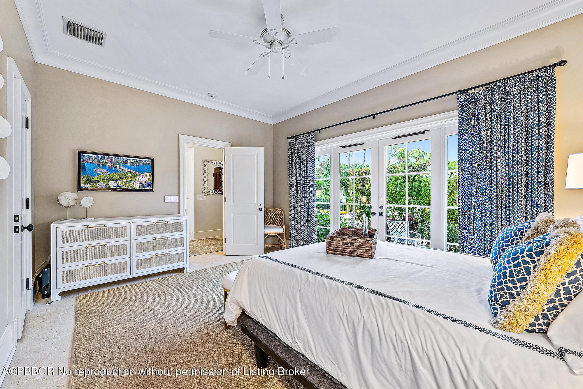 165 Root Trail Palm Beach, FL 33480 - Photo 15 of 26 a bedroom with a bed and a large window