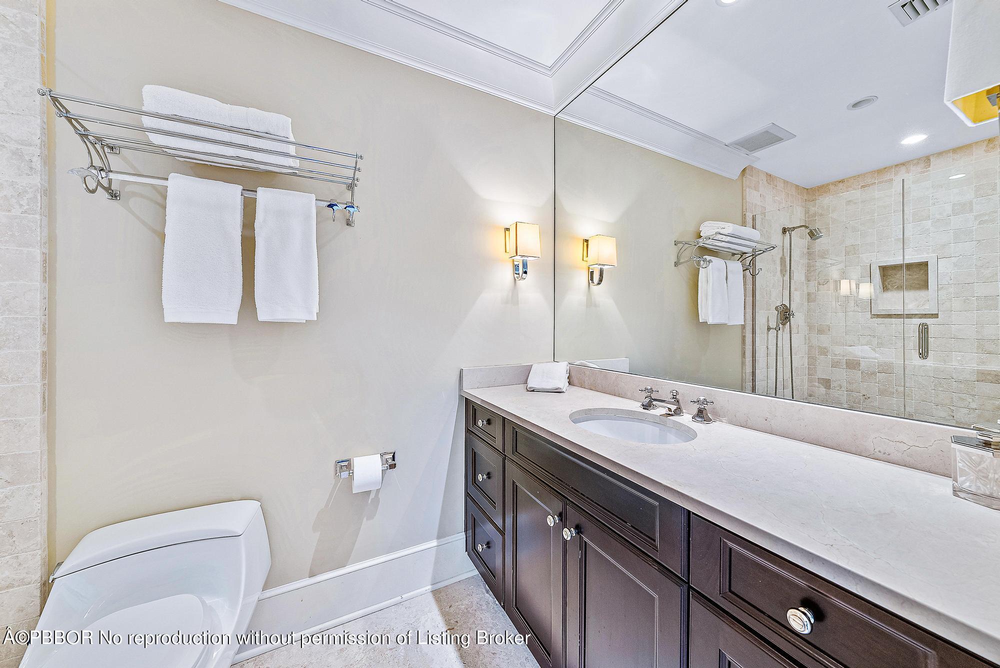 165 Root Trail Palm Beach, FL 33480 - Photo 16 of 26 a en suite bathroom with a granite countertop sink and a mirror
