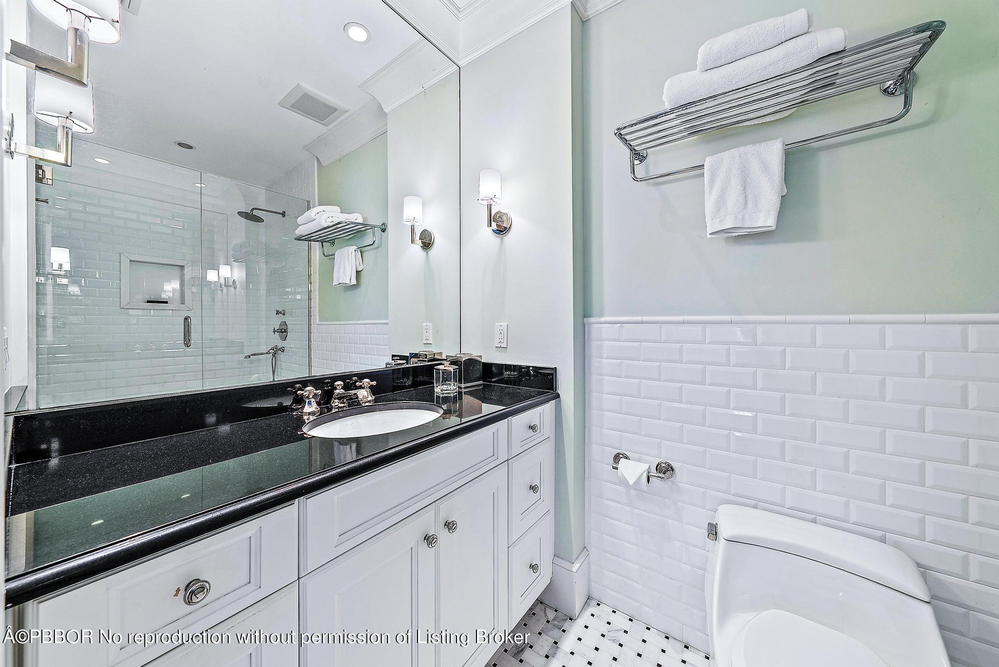 165 Root Trail Palm Beach, FL 33480 - Photo 20 of 26 a bathroom with a sink a toilet a vanity and shower