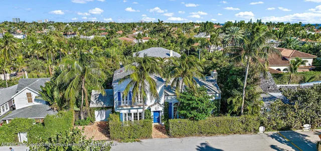 a view of a house with potted plants and a clock on the wall