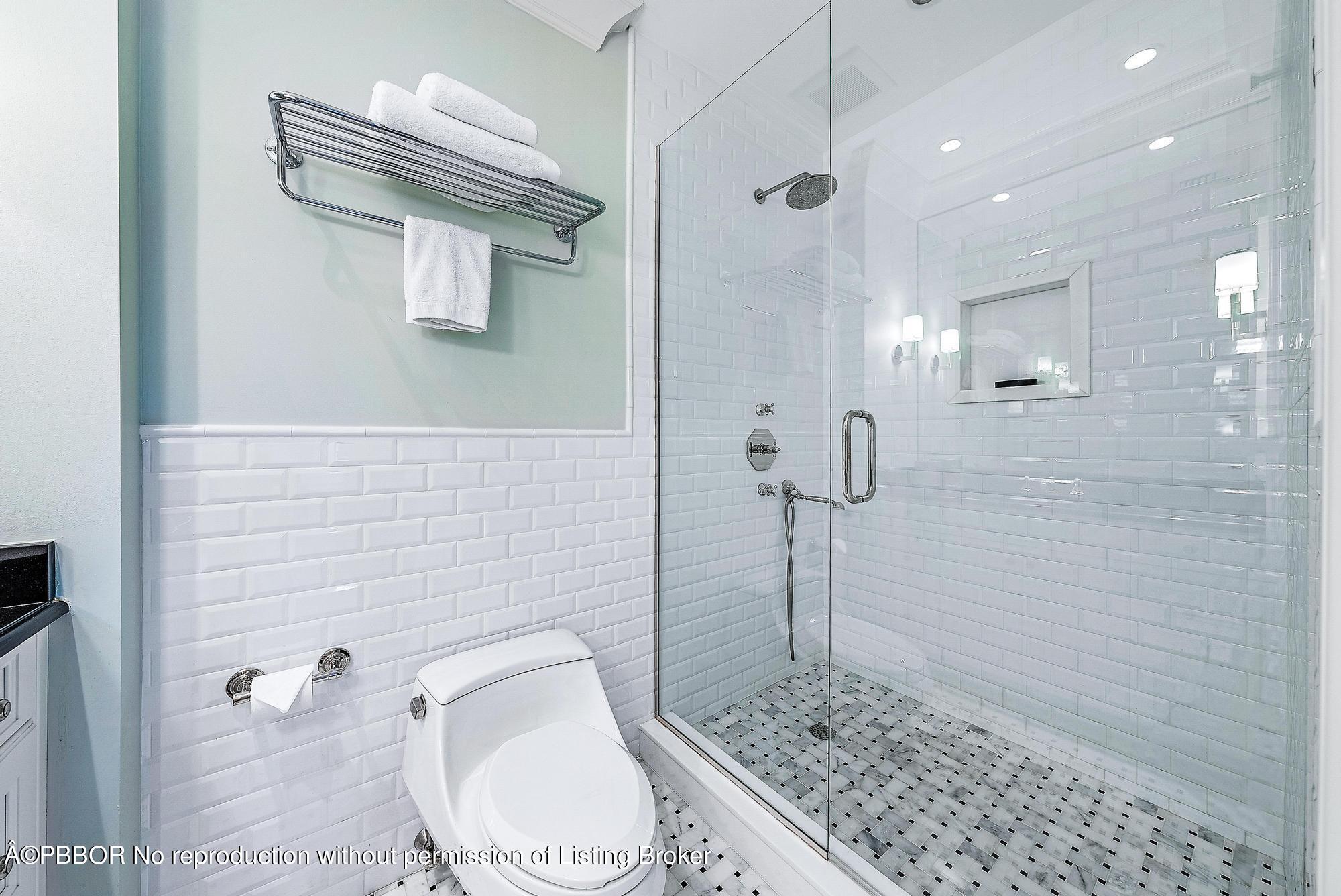 165 Root Trail Palm Beach, FL 33480 - Photo 21 of 26 a bathroom with a granite countertop sink a toilet and shower