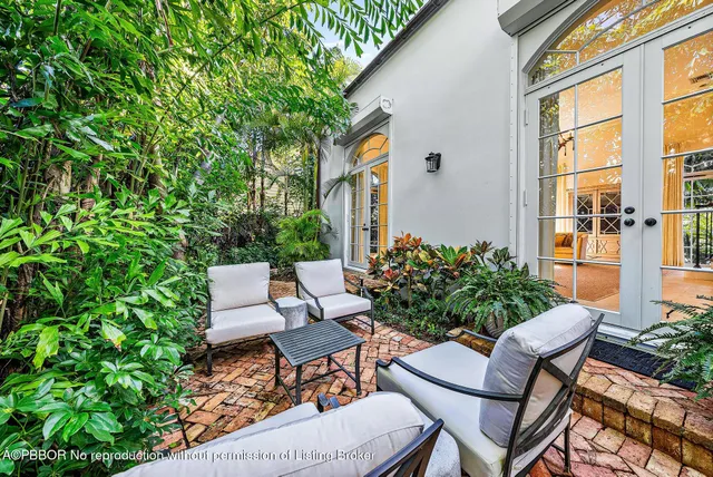 a backyard of a house with table and chairs