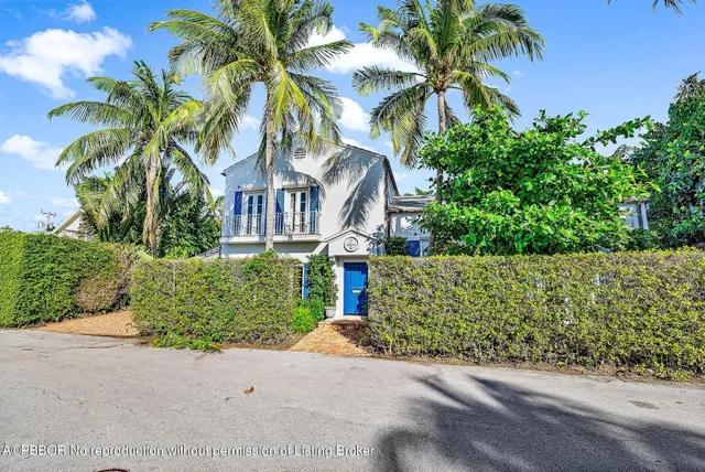 a living room with furniture potted plant and a large window