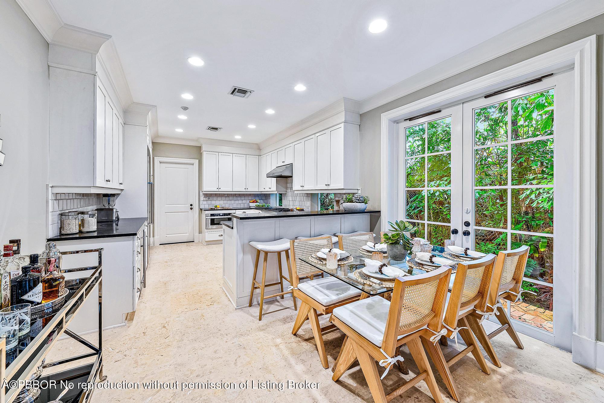 165 Root Trail Palm Beach, FL 33480 - Photo 9 of 26 a dining room with furniture and a kitchen view