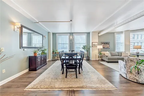 a view of a dining room with furniture and wooden floor