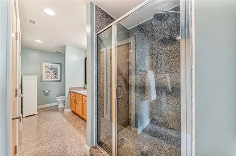 a bathroom with a granite countertop double vanity sink and a mirror