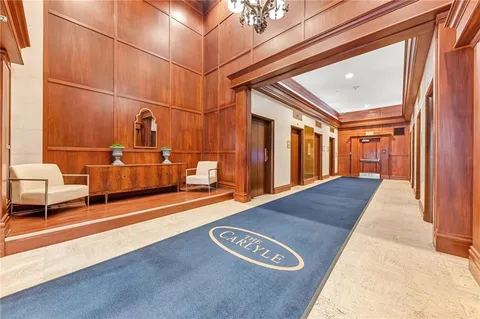 a kitchen with stainless steel appliances kitchen island granite countertop a refrigerator and a stove top oven